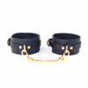 Leather shackles with gold chains