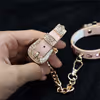Pink diamond handcuffs with gold chains