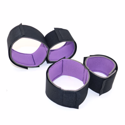 SM bondage handcuffs, black and purple restraint straps