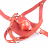 Red leather gag with hollow hard ball.