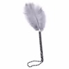 Gray ostrich feathers wrapped around a black and white handle