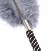 Gray ostrich feathers wrapped around a black and white handle