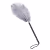 Gray ostrich feathers wrapped around a black and white handle